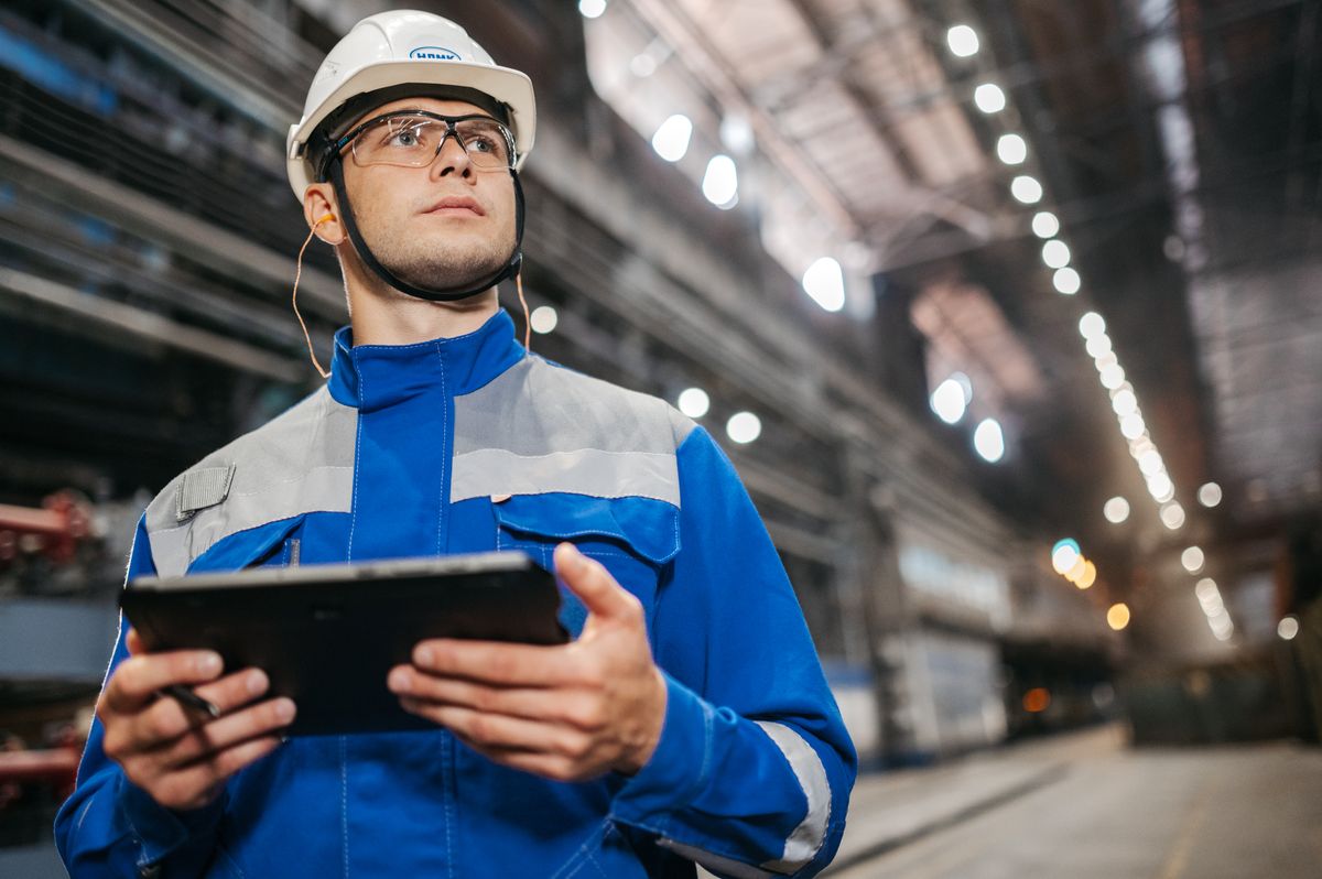 Engineer using a tablet in a plant hall